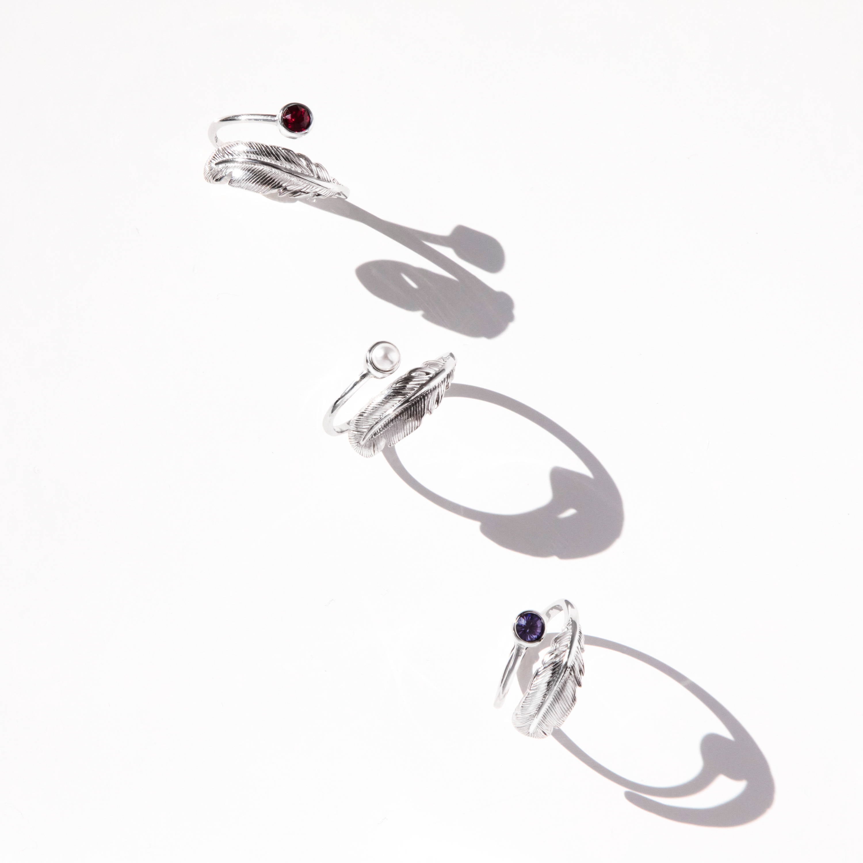 silver feather birthstone rings with shaddows