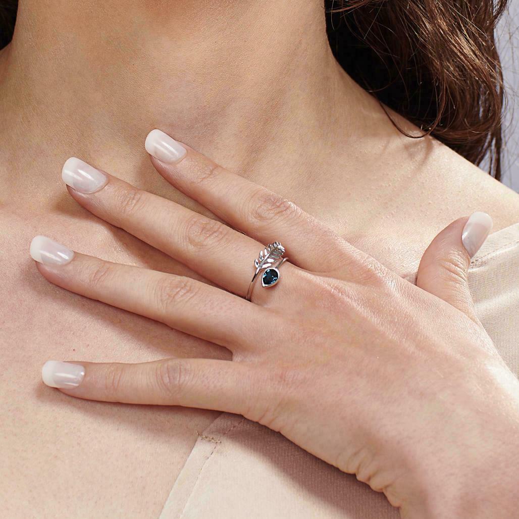 Woman wearing a FIYAH silver leaf birthstone ring