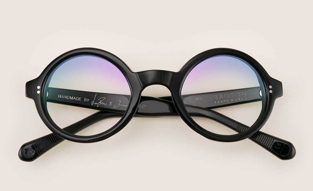 Black circular glasses frame lying folded