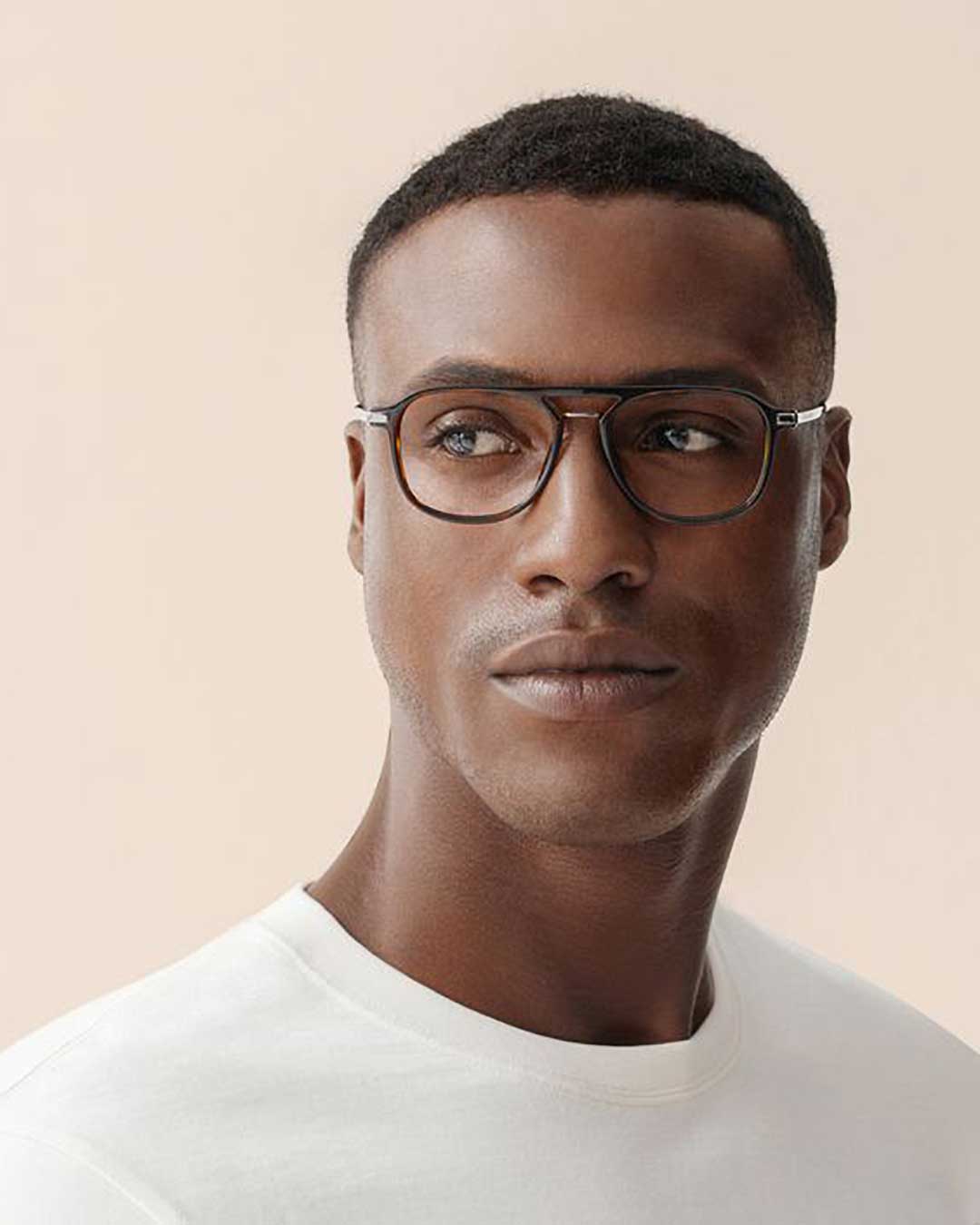 Black man with short hair wearing white shirt and tortoise Aviator eyeglasses frame