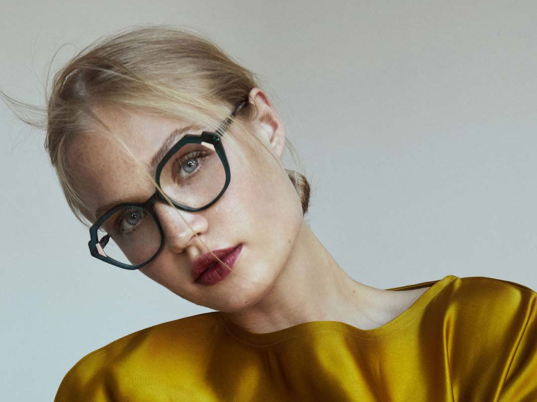 Blonde female wearing geometric style eyeglasses