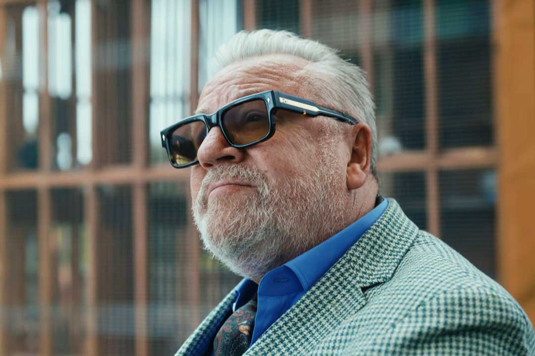 Bobby Glass wearing thick frame rectangular sunglasses in the Gentleman Netflix action comedy series