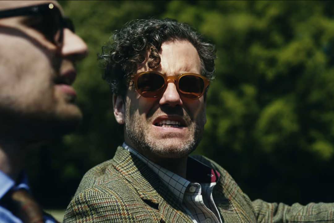 Character Freddy Horniman wearing amber coloured thick frame sunglasses in the Netflix drama series The Gentleman