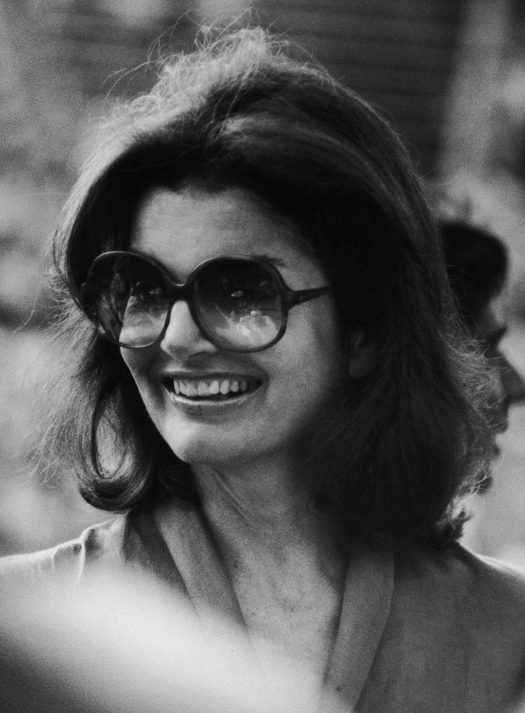 Close view of Jackie O wearing large oversized sunglasses
