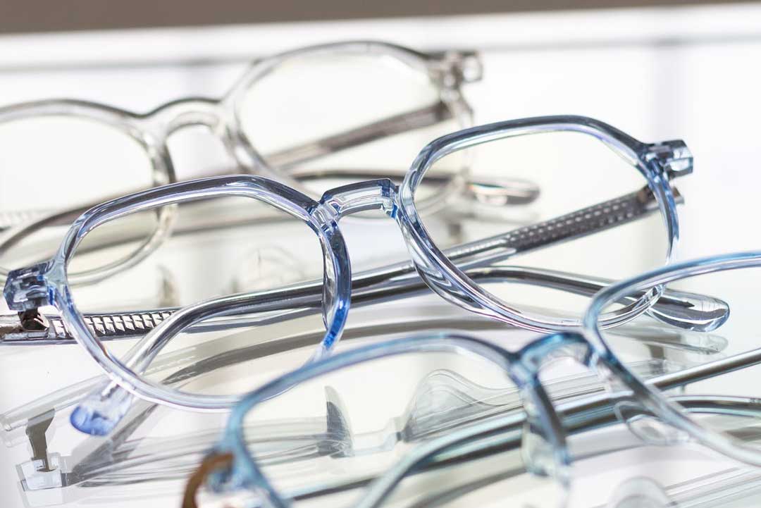 Close view of three transparent framed eyeglasses
