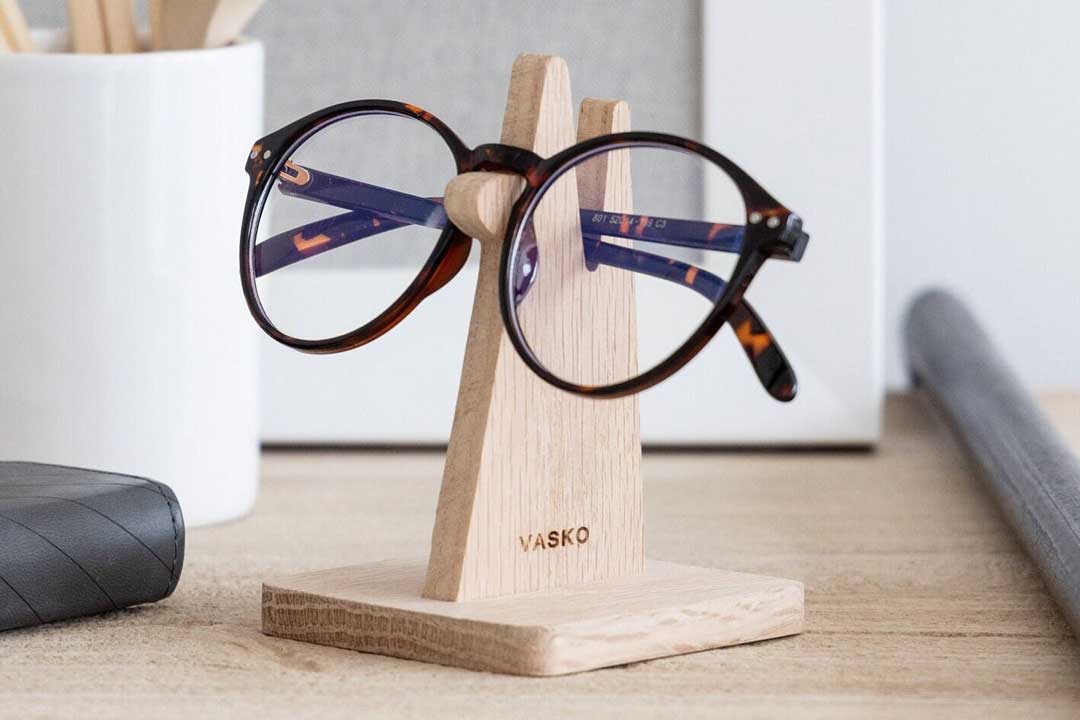 Close view of wooden spectacles stand on office desk