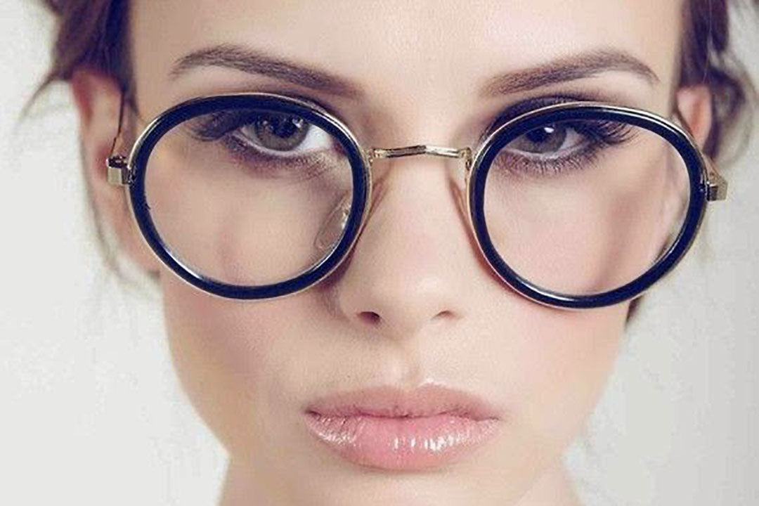 Close view of young lady wearing large round eyeglasses with black rims