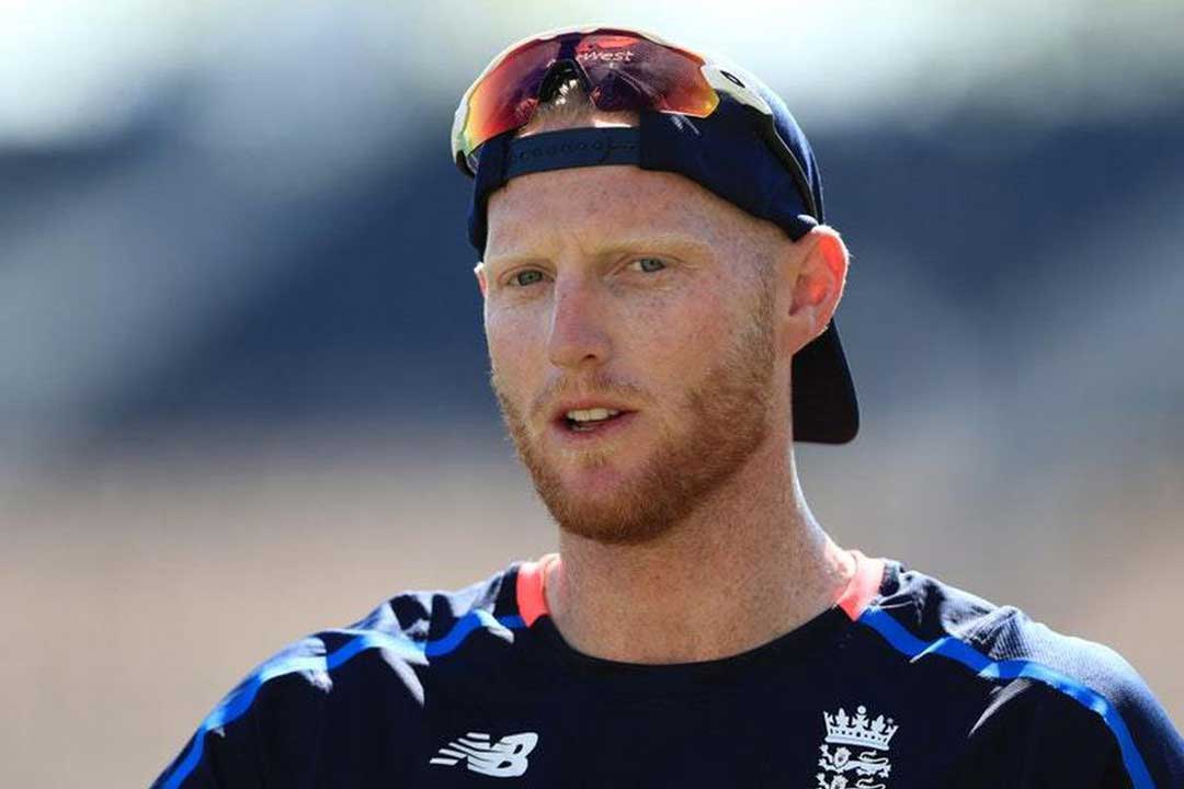 Cricket player Ben Stokes wearing blue England uniform, cap and mirror tinted sunglasses frame