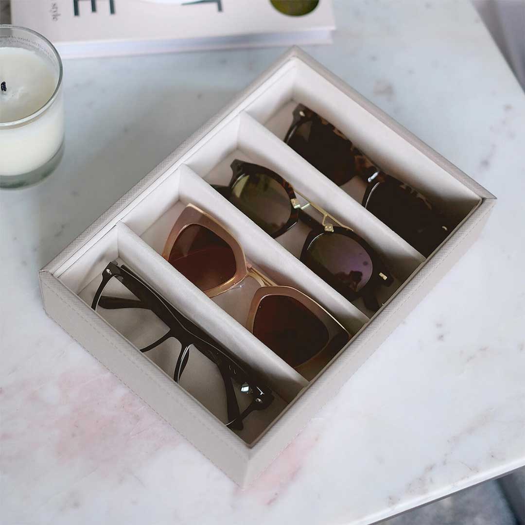 Dusty pink sunglasses organiser box lying on marble table