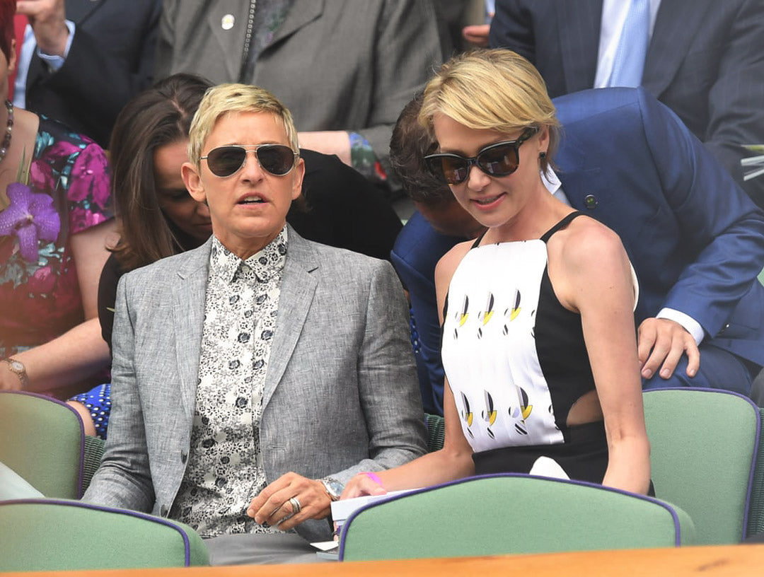 Ellen DeGeneres sitting in the Wimbledon crowd wearing large aviator sunglasses