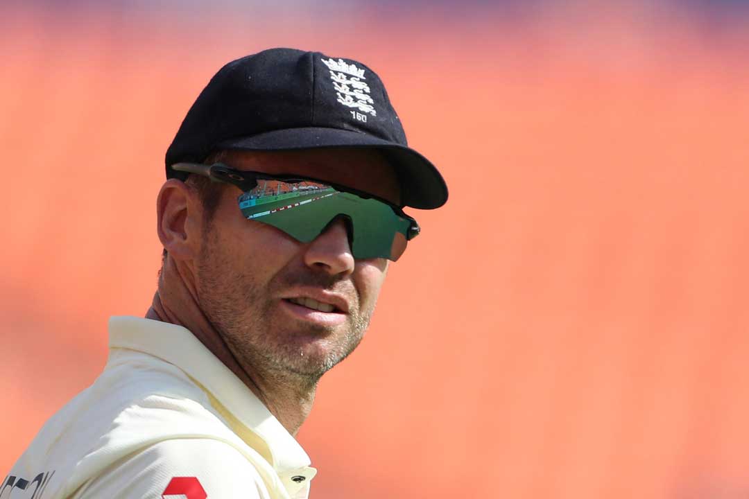 English cricket player wearing blue cap, white shirt and mirror lens sunglasses frame