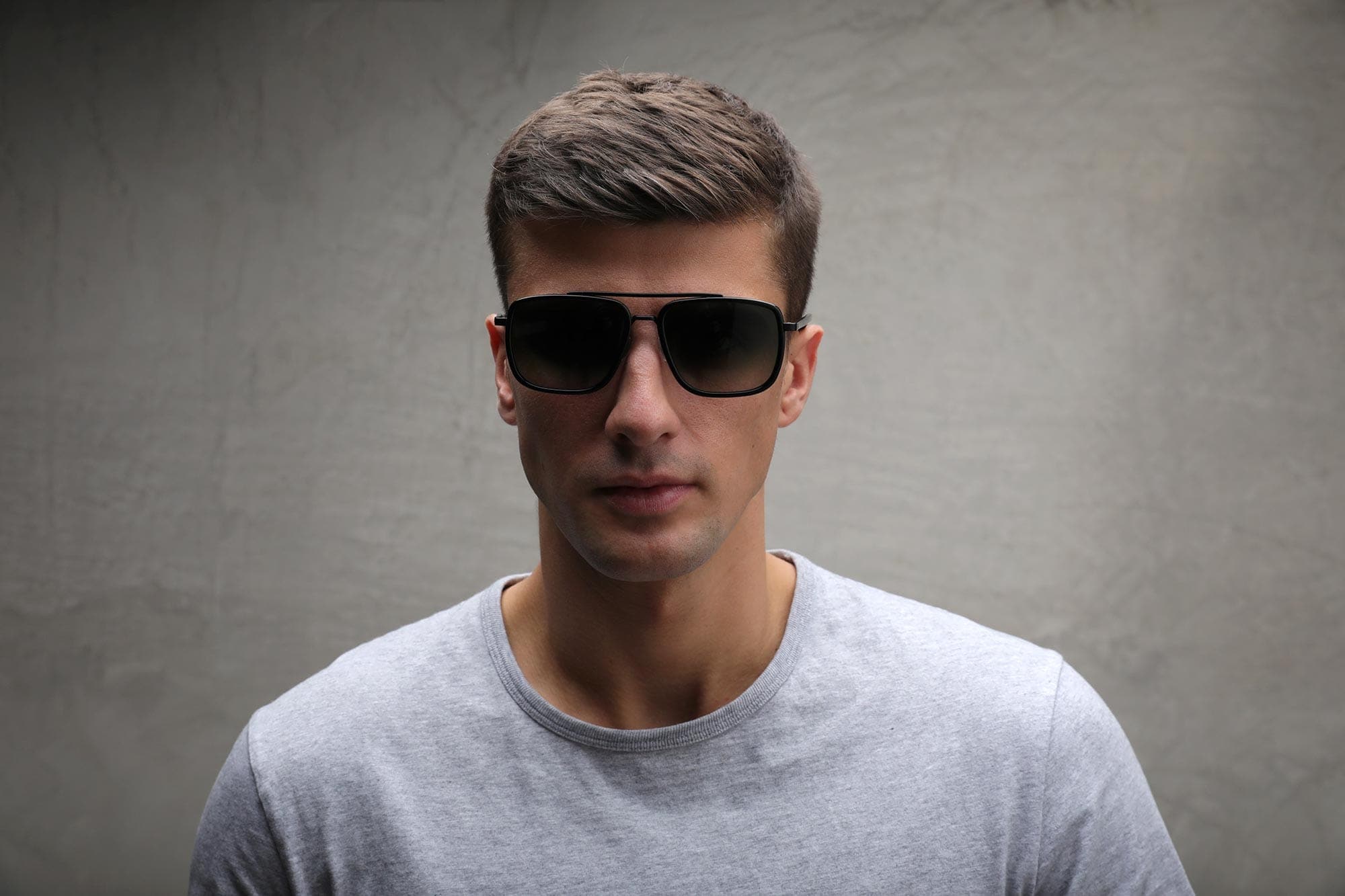 Front view of man wearing chunky black Aviator sunglasses frame with gradient lenses
