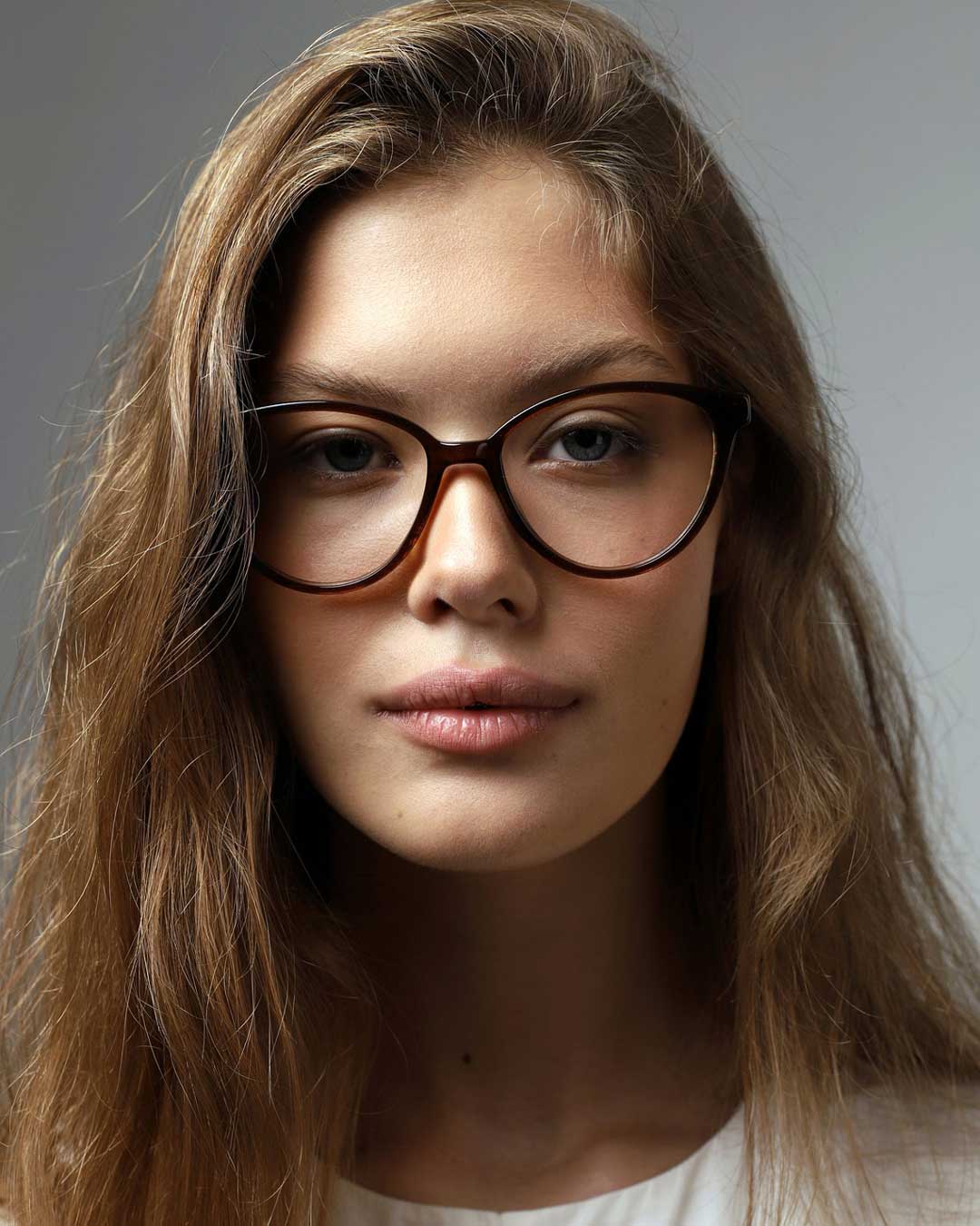 Front view of woman wearing dark brown cat eye spectacles frame