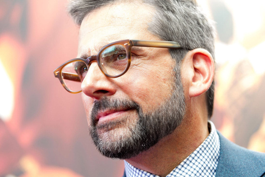 Gentleman with salt and pepper hair wearing amber and black spectacles