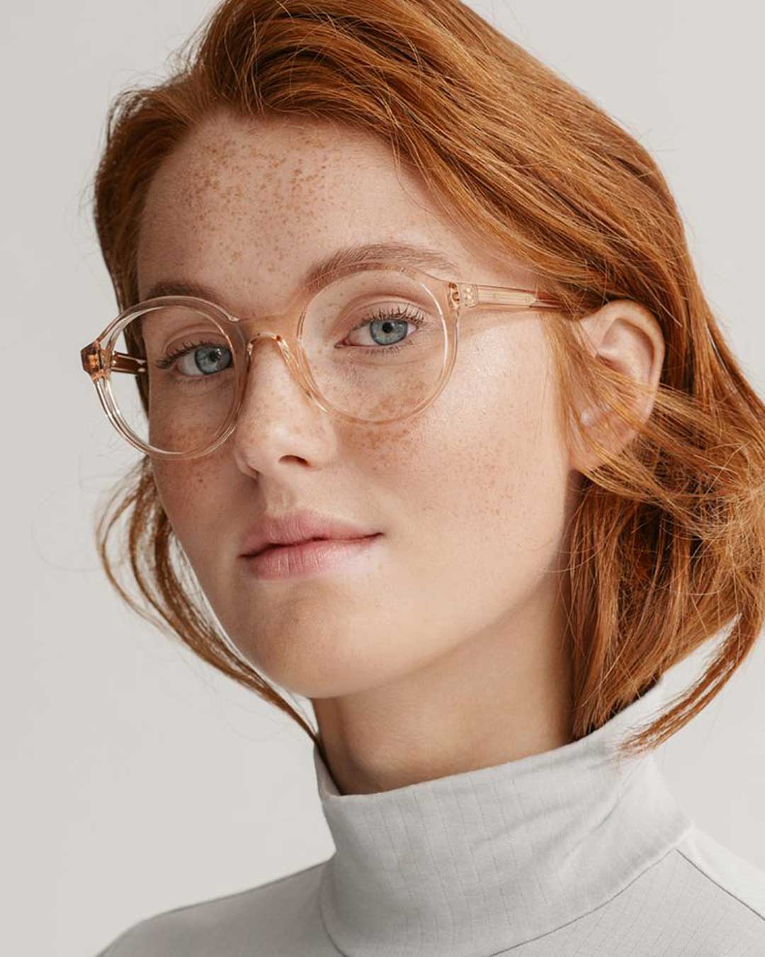 Ginger haired woman wearing round crystal eyeglasses frame