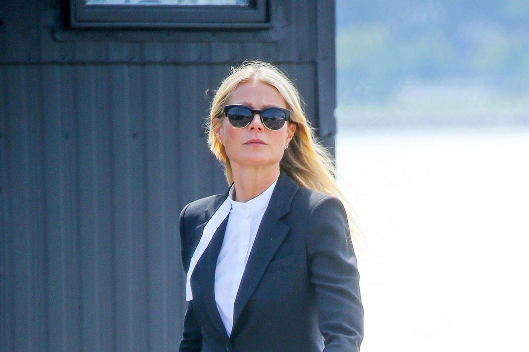 Gwyneth Paltrow wearing formal suit jacket white shirt and clubmaster sunglasses outside