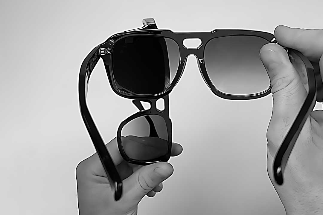Illustration of person holding two sunglasses frames overlapping each other