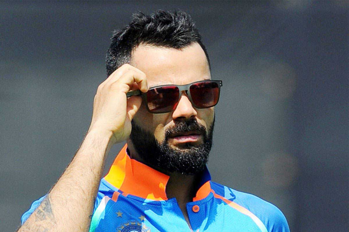 Indian cricketer Virot Kohli wearing square grey sunglasses frame with red tinted lenses