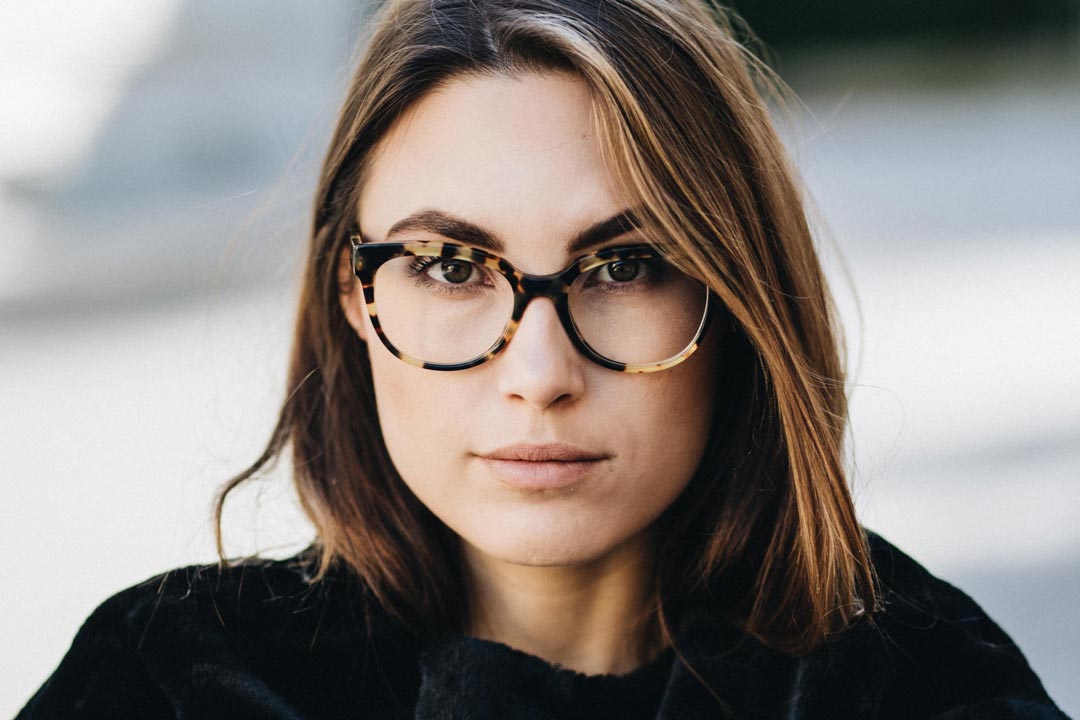 Silhouette of man's head in hipster glasses with forest in hair