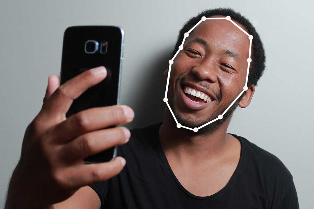 Man using phone to scan his face shape