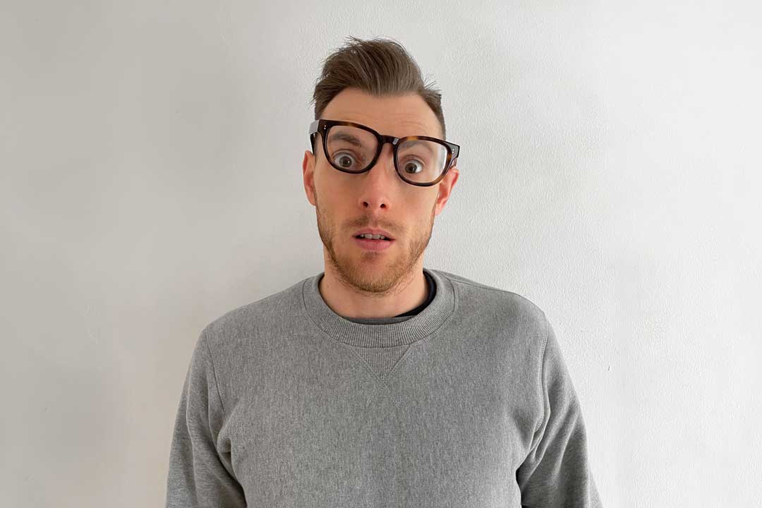 Man wearing crooked glasses frame with surprised look on his face
