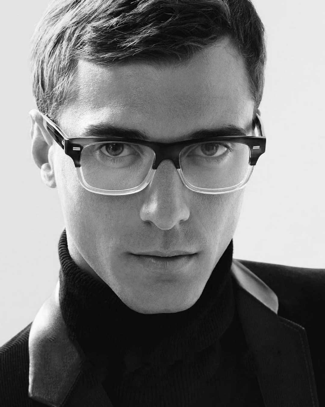 Man with short hair wearing chunky two tone gradient glasses frame