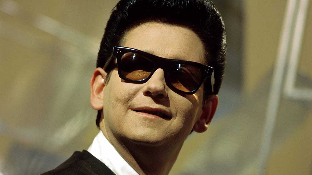 Mature man wearing black suit and 50s style sunglasses frame