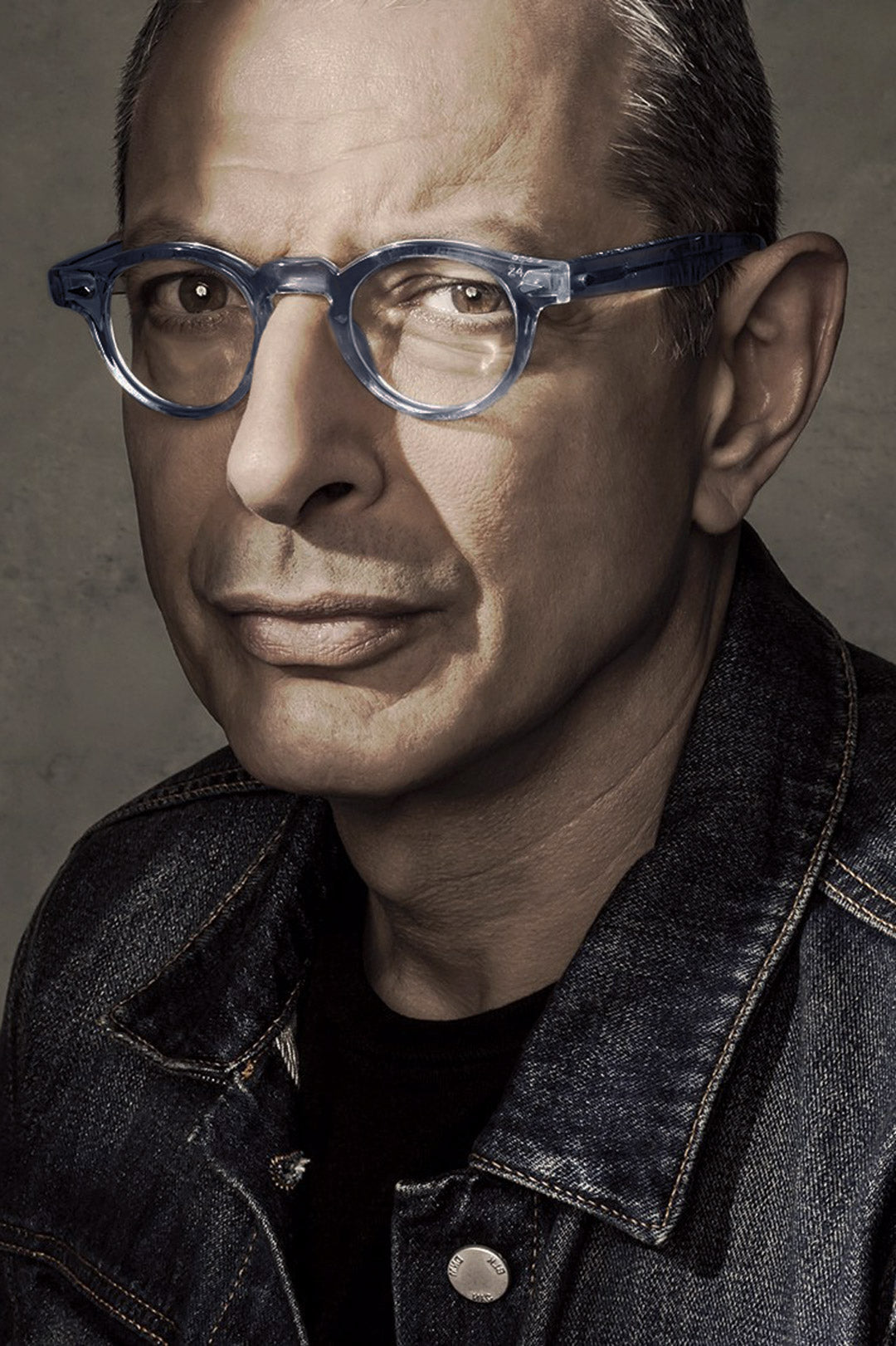 Mature-man-wearing-round-blue-eyeglasses-and-denim-jacket