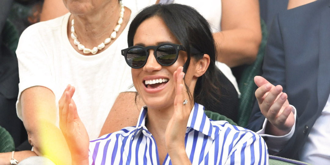 Meghan Markle at Wimbledon wearing stripey blue shirt and round black sunglasses
