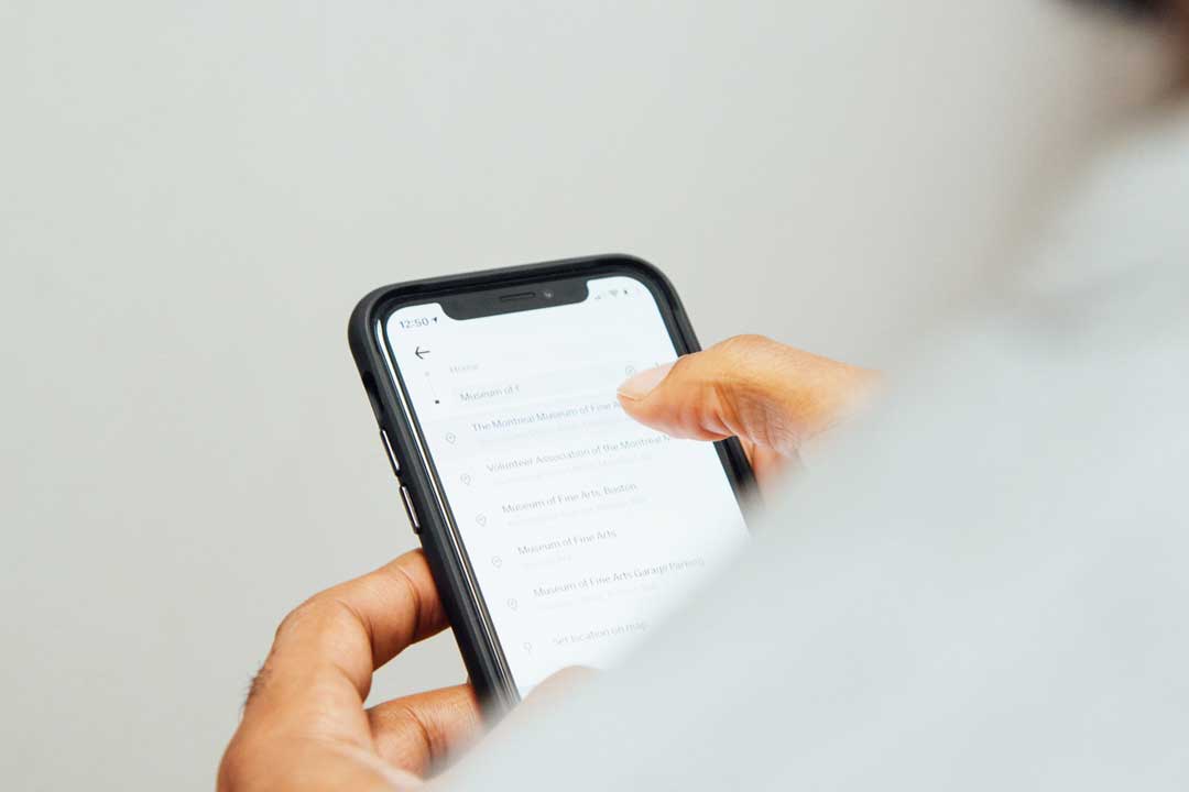 Over the shoulder view of person using their smartphone