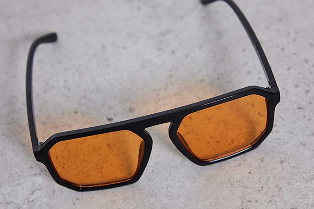 Oversized black Aviator sunglasses with orange tinted lenses