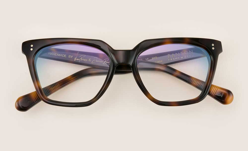 Rectangular shaped tortoise shell acetate glasses frame lying folded