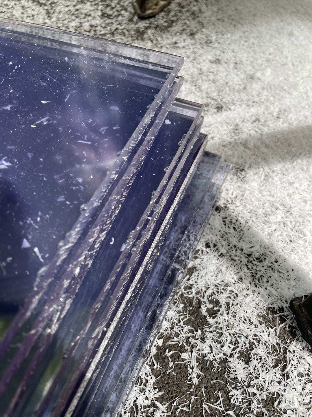 Sheets of cellulose acetate cut into strips on workshop floor