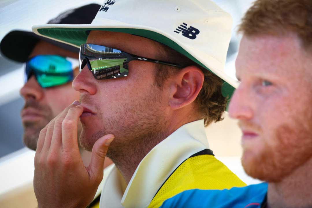 Side view of cricketer Stuart Broad wearing Oakley sunglasses frame sitting beside Ben Stokes