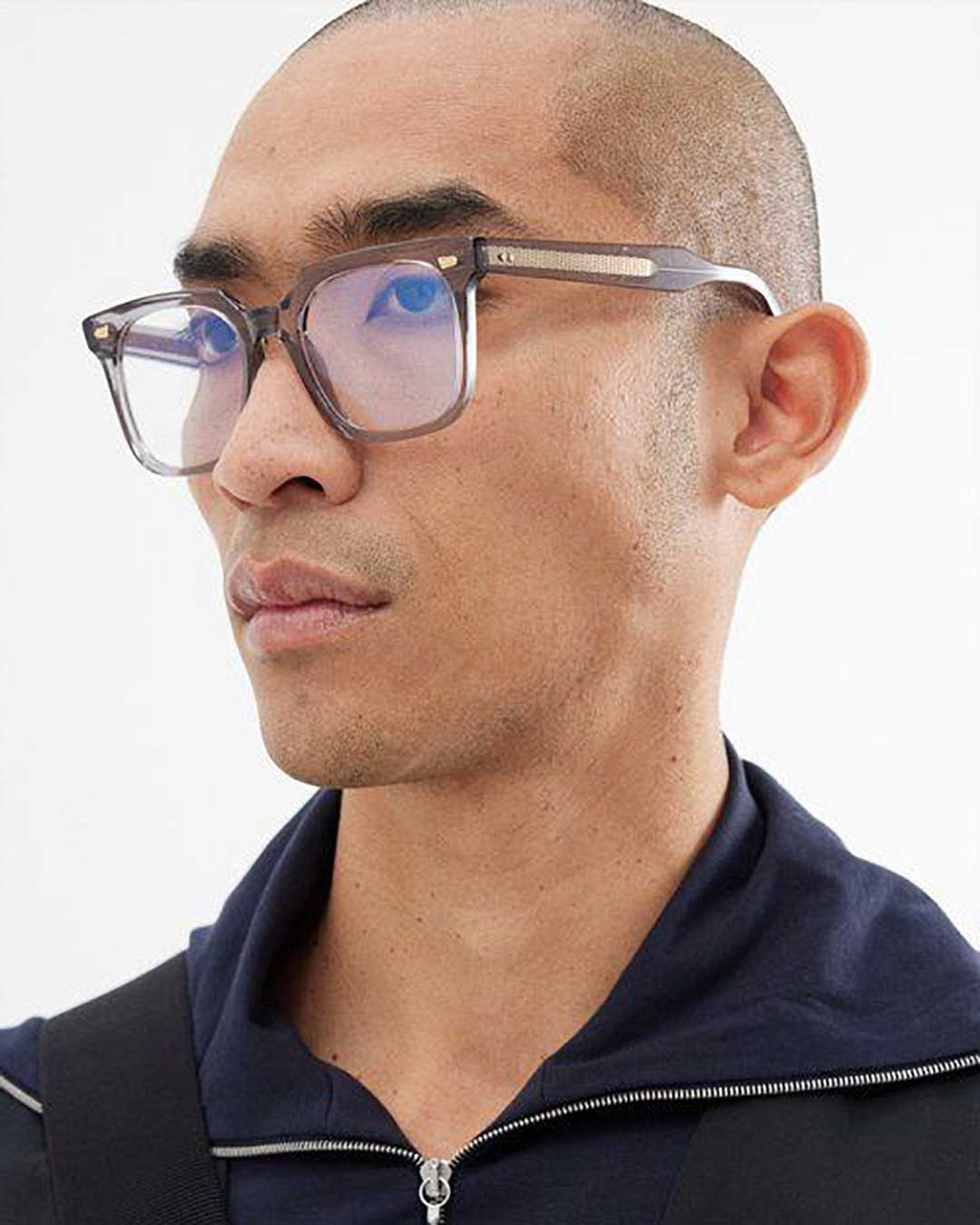 Side view of man wearing large square crystal eyeglasses frame