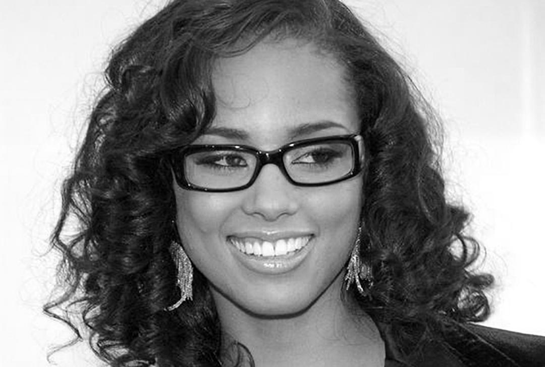 Smiling woman wearing thick black rectangular spectacles