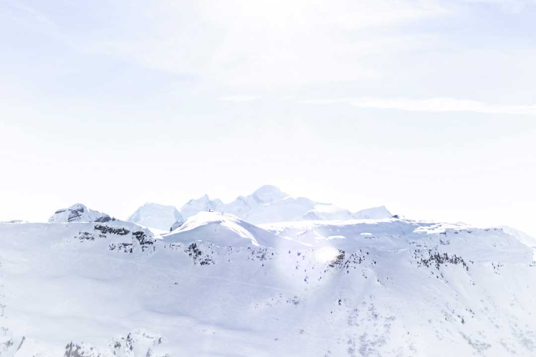 Snow covered mountains on bright sunny day