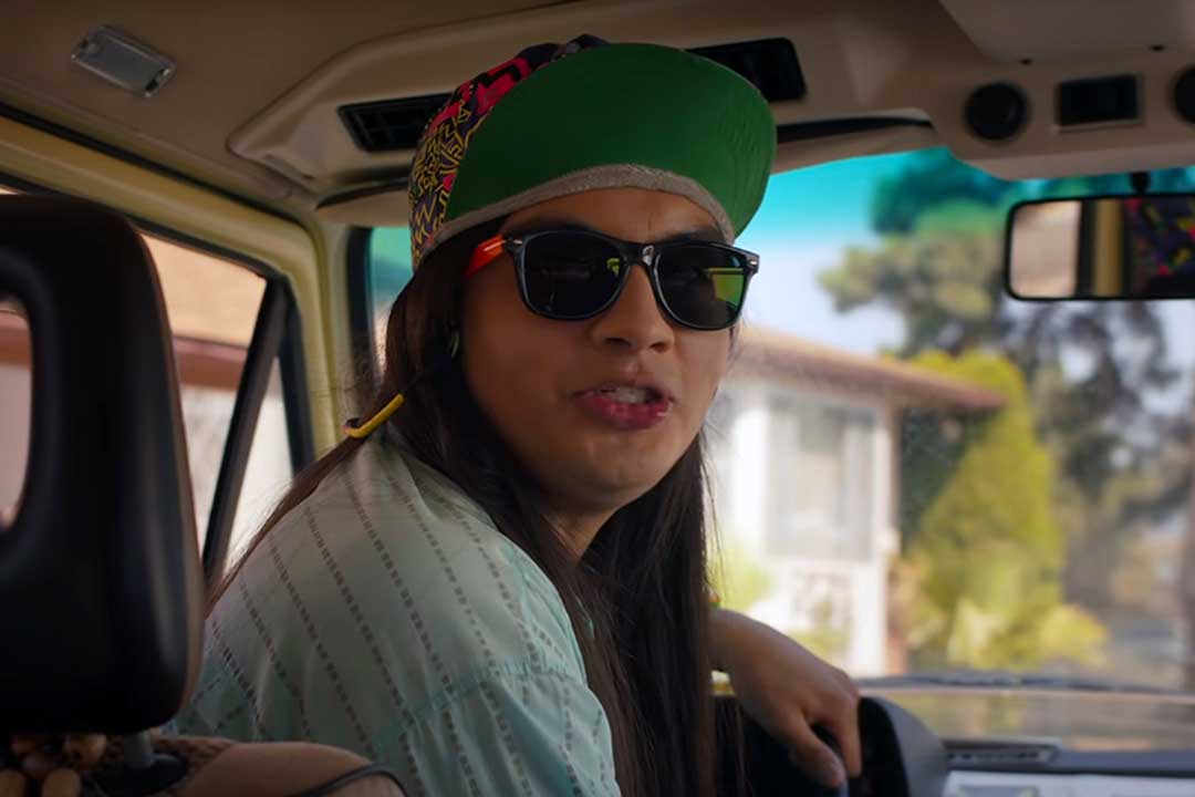 Stranger Things character Argyle inside pizza van wearing cap and sunglasses