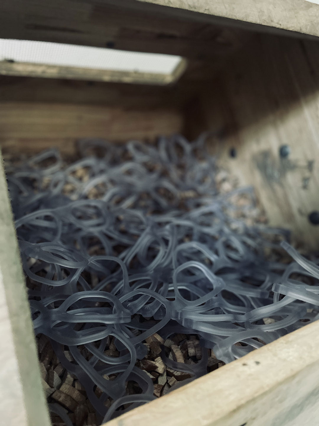 Sunglasses frames inside wooden tumbling chamber for manufacture