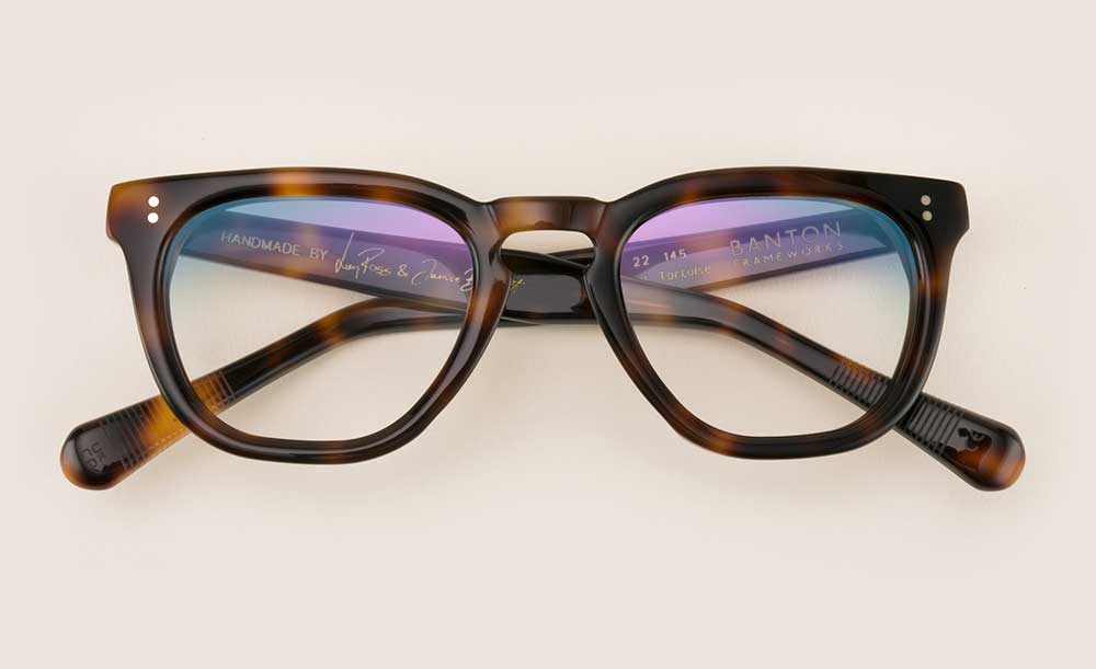 Thick rimmed tortoise shell acetate spectacle frame lying folded