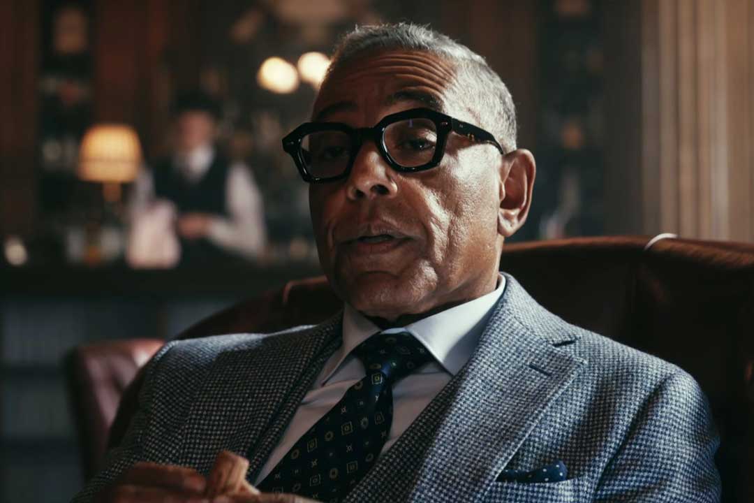 Three quarter view of Stanley Johnston wearing thick frame Ahlem glasses in the Netflix drama The Gentleman