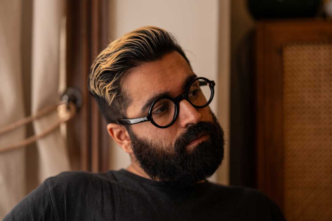 Three quarter view of bearded man wearing round eyeglasses