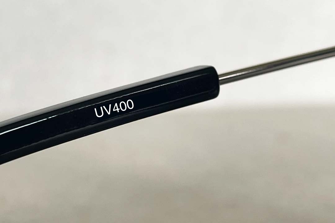 UV400 printed on the inside of a black sunglasses arm