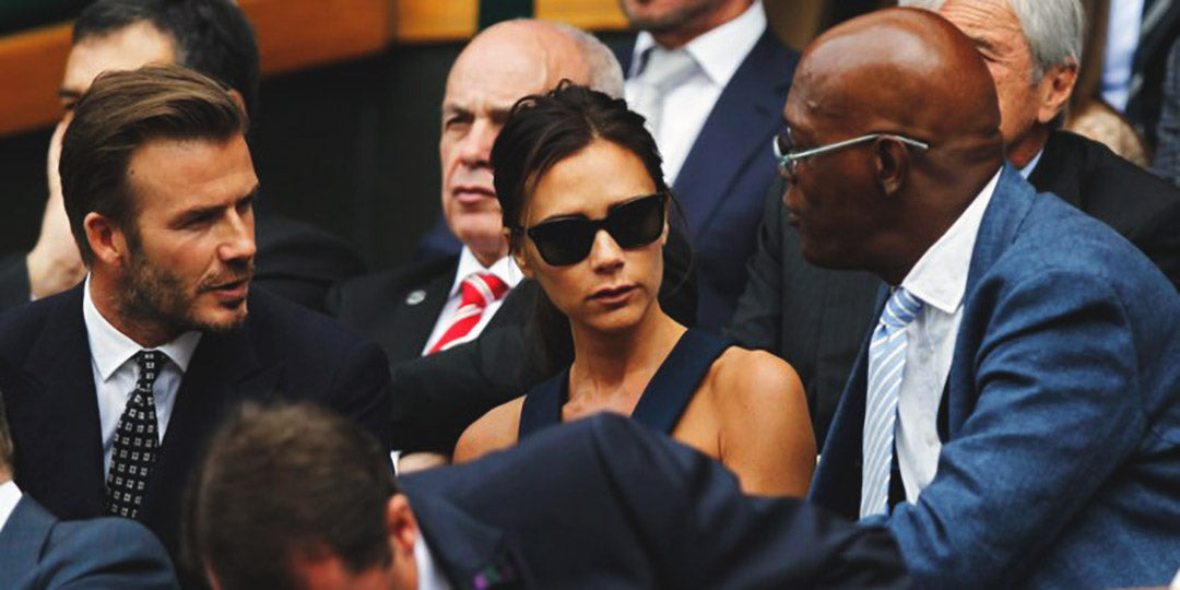 Victoria Beckham seated beside husband David Beckham at Wimbledon speaking with Samuel L Jackson