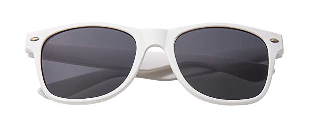 White Wayfarer sunglasses frame with dark lenses lying folded on white background