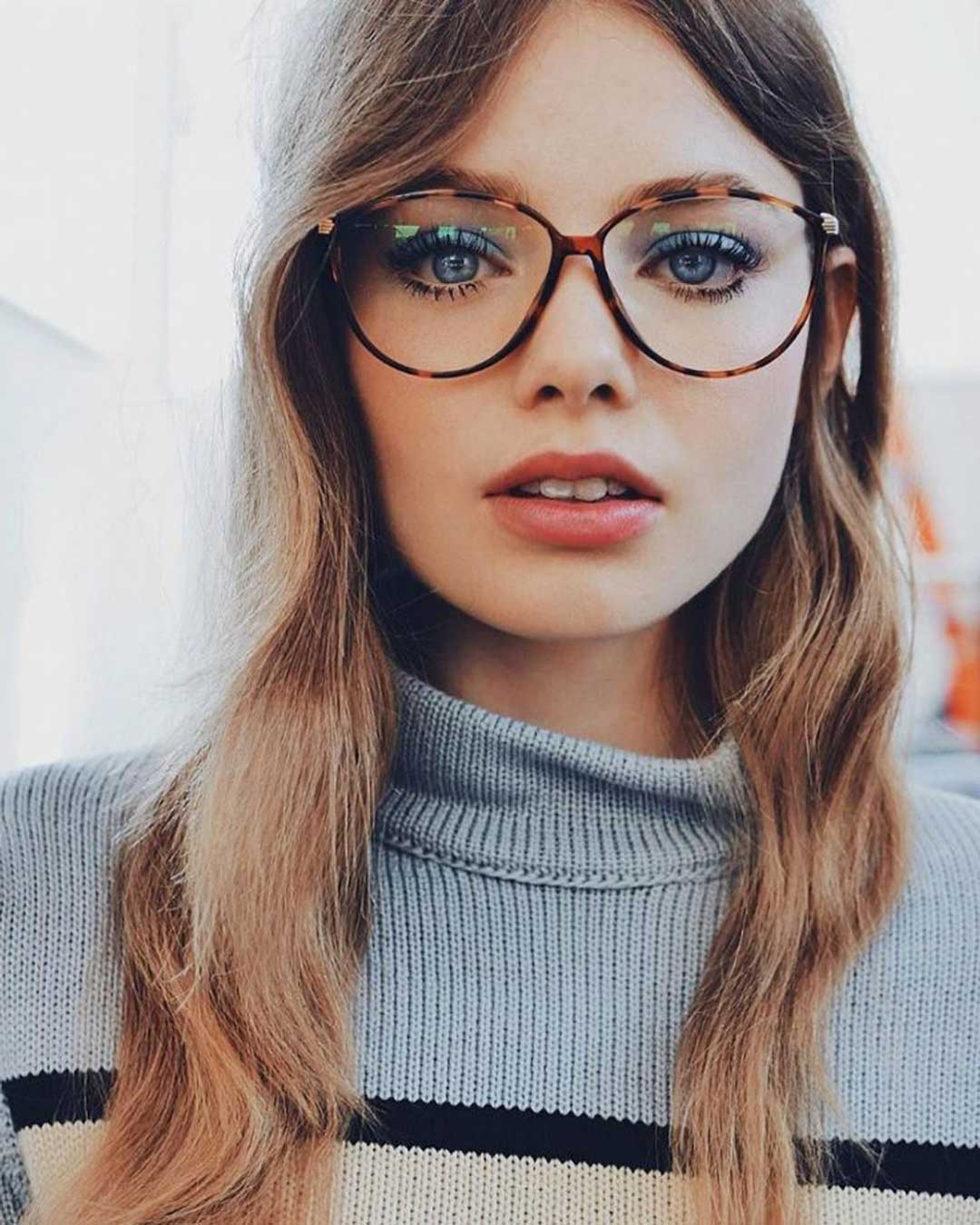 Woman in striped sweater wearing vintage cat eye glasses frame