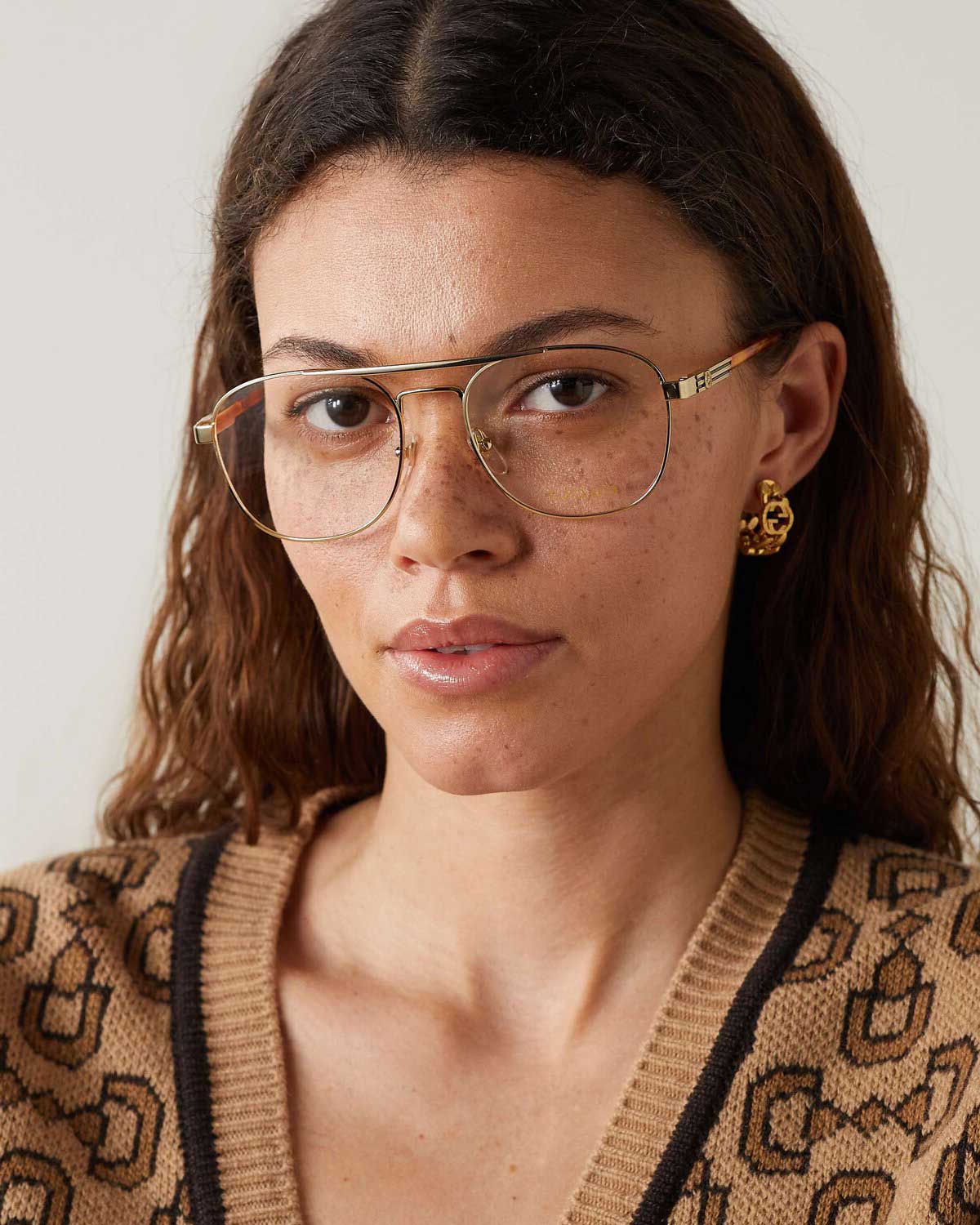 Woman wearing gold wire Aviator spectacles frame