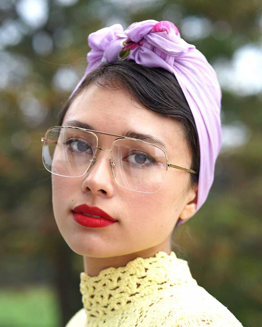 Woman wearing pink head scarf and Aviator eyeglasses
