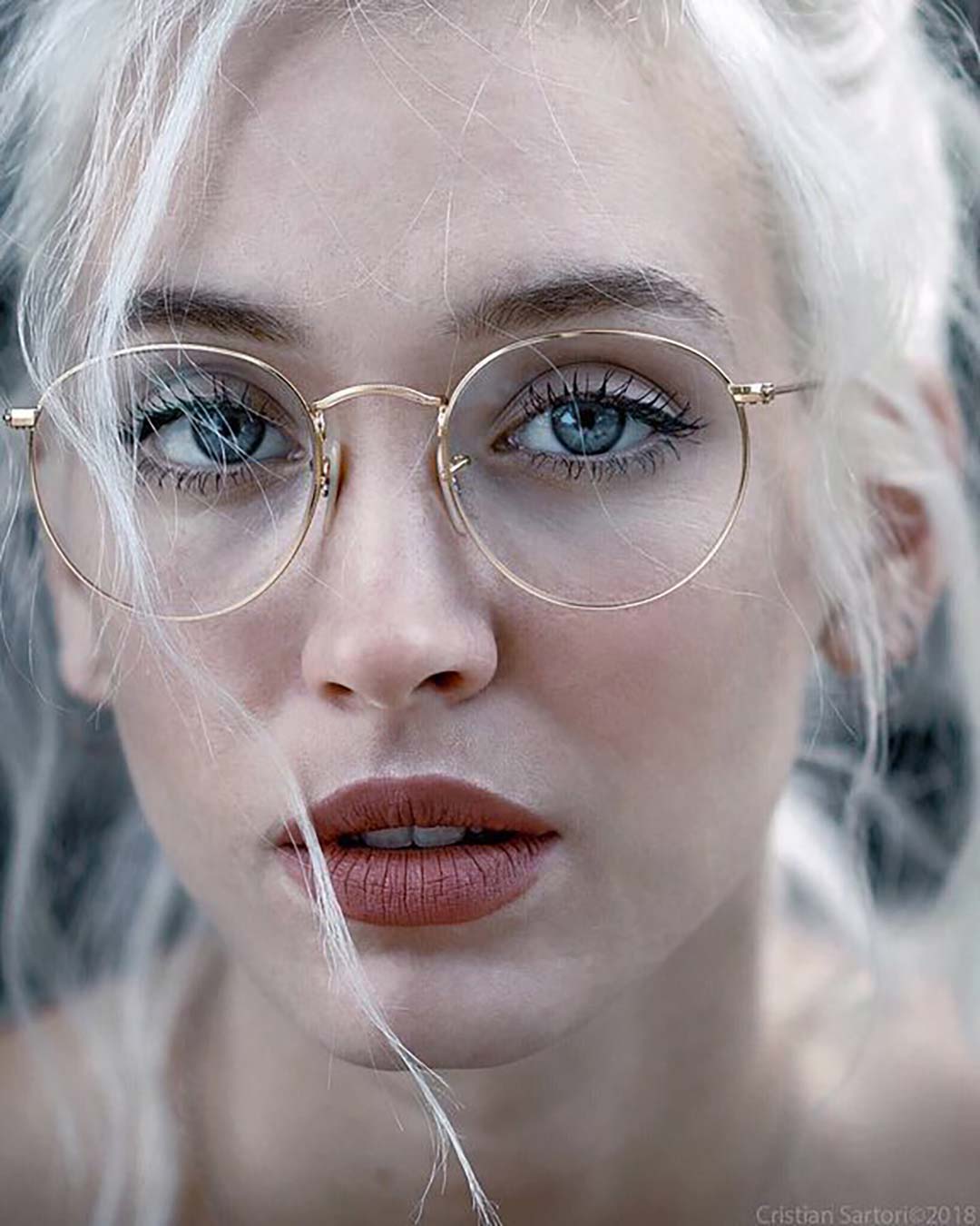 Woman wearing rose gold wire eyeglasses