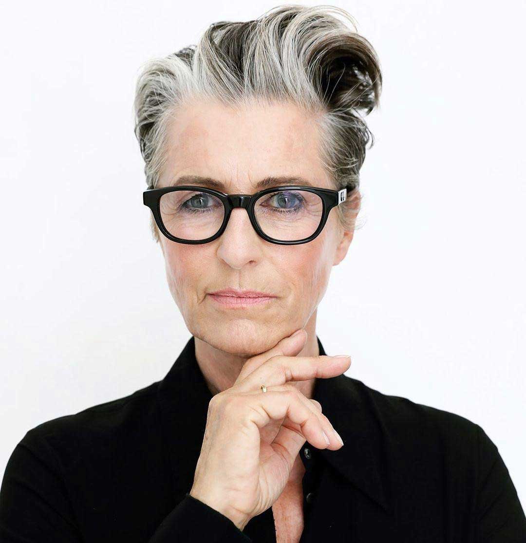 Woman with short grey haircut wearing oval black eyeglasses frame